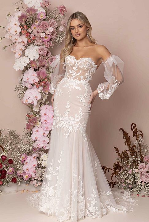 Model wearing a white gown by Madi  Lane. Mobile image