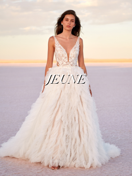 Model wearing a white gown by Jeune Bridal