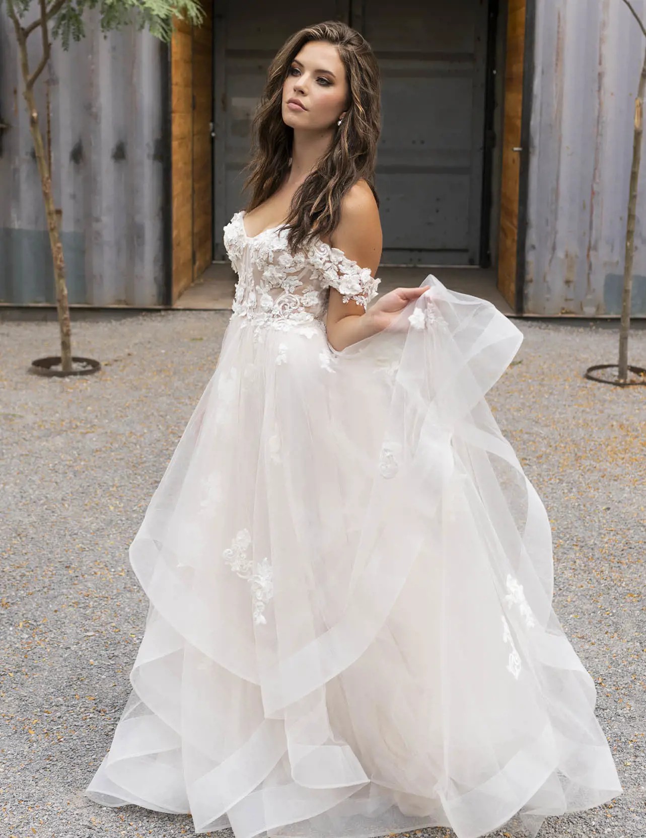 Model wearing a white gown by Mia Solano